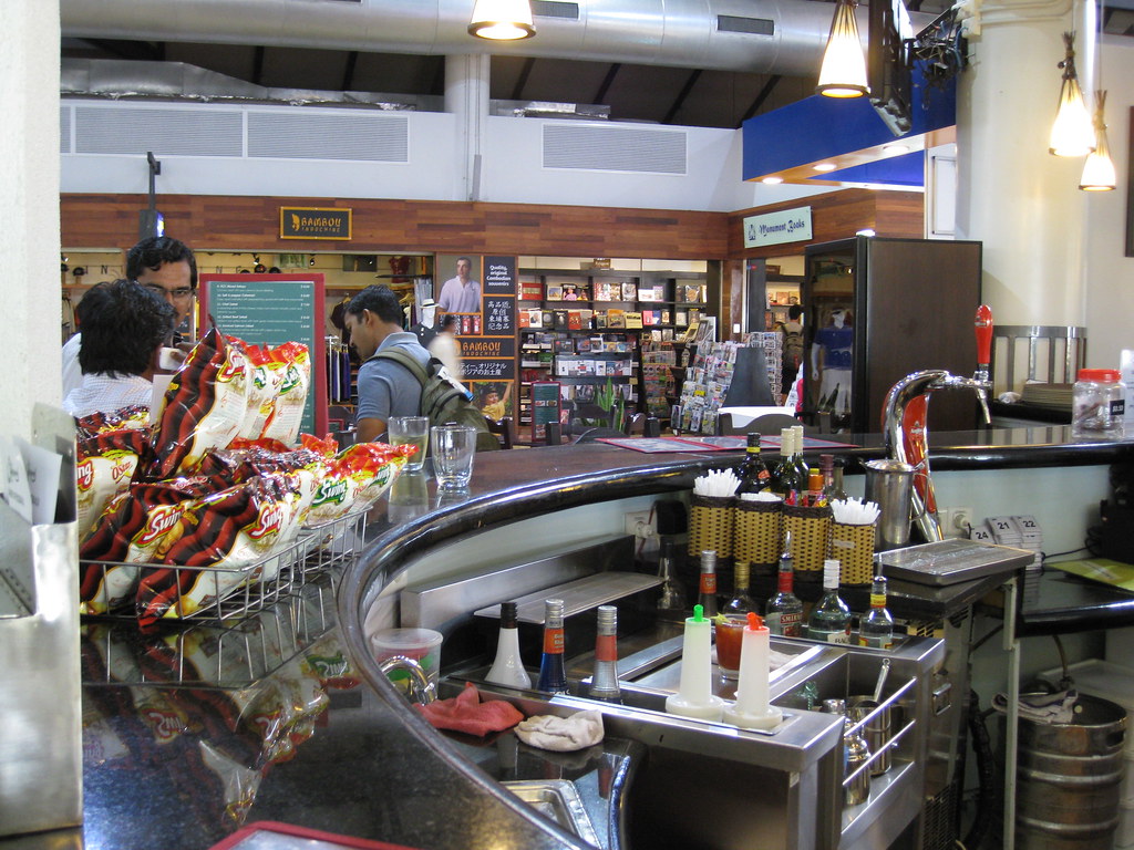 A customer paying at a small shop counter