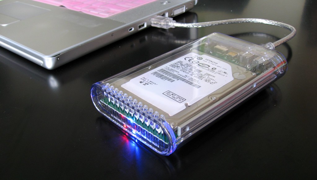 An external hard drive connected to a laptop for backup