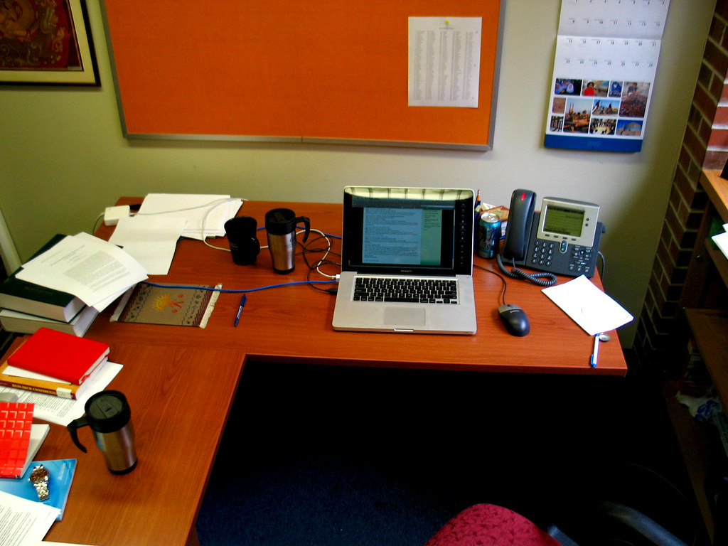 An employee working on a laptop in an office