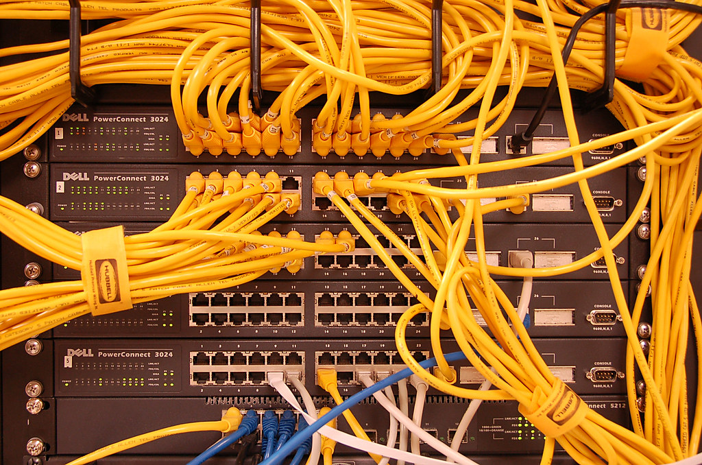 Network cables connected to servers in a rack