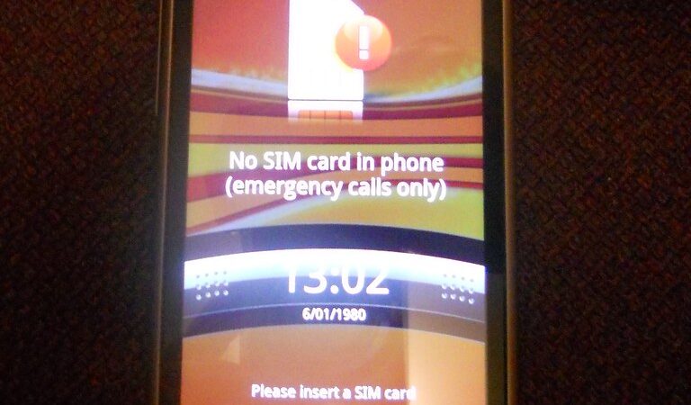 A SIM card being inserted into a smartphone