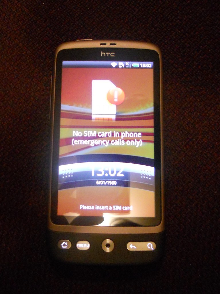 A SIM card being inserted into a smartphone